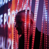 A portrait of artist Riccardo Benassi amid LED light installations.