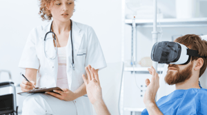 Focused young female doctor watching male gesticulating patient in VR