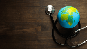 A decorative globe resting on a table, with a medical stethoscope nearby