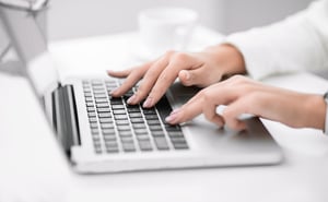hands typing on the laptop keyboard