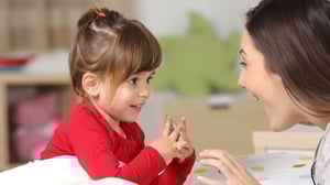 Mum talking to her daughter while smiling
