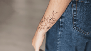 A woman's arm with a floral tattoo